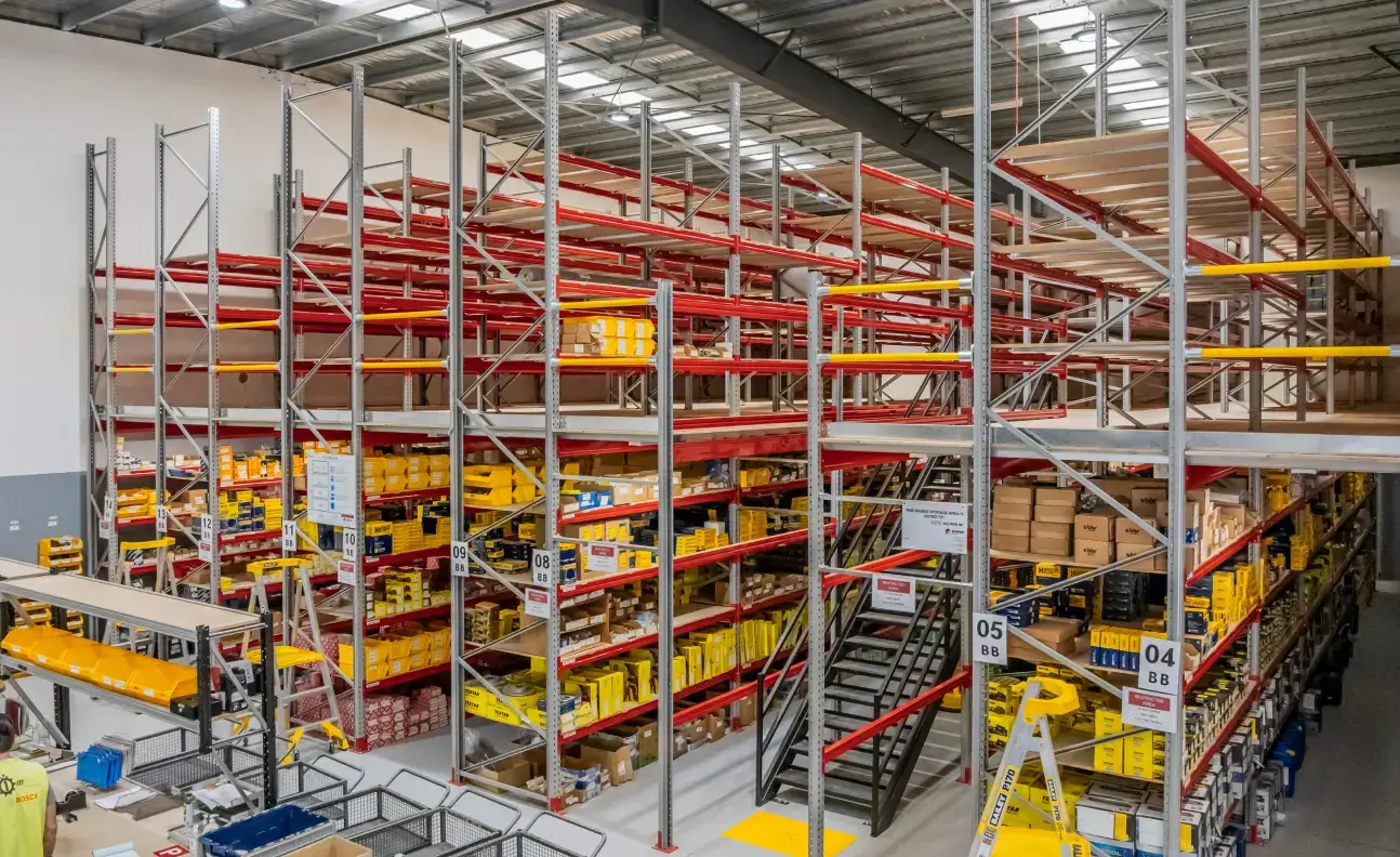 Forklift operating within a drive-in warehouse racking system designed to improve storage efficiency.